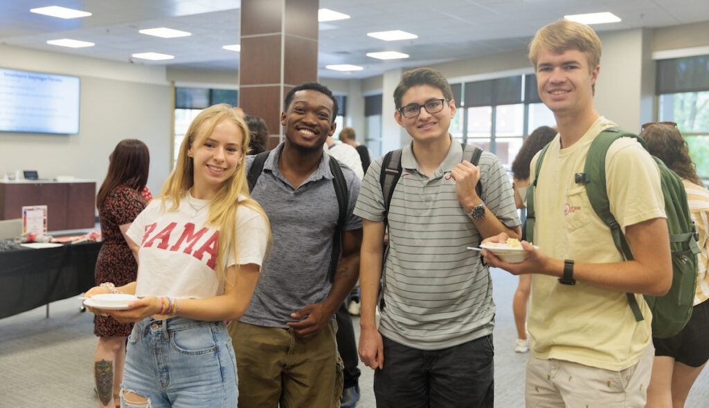 four students smiling